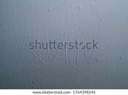 The inscription "run" drops of water on the surface