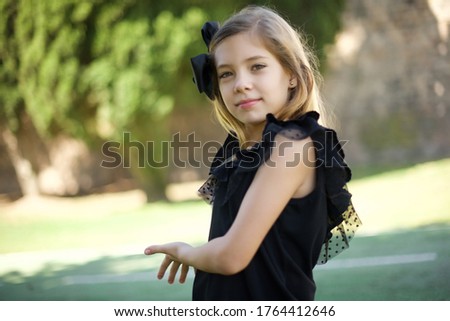 Young beautiful caucasian little girl standing outdoors  over isolated background Inviting to enter smiling natural with open hands. Welcome sign.