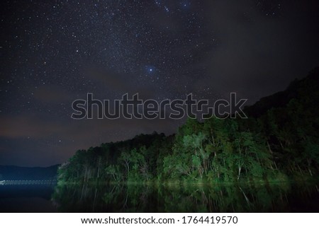 night landscape view milkyway and star reflection on water in dam