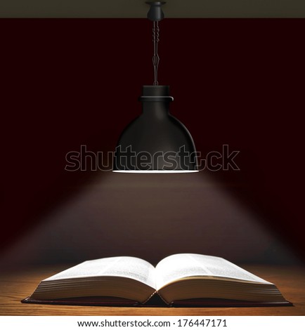 One Book on wooden table under lamp 