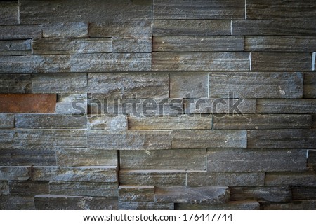Stone feature wall with vignetting suitable as a background or texture.