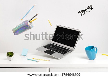 Office supplies stationery levitate over white table. Back to school work education creative layout Royalty-Free Stock Photo #1764548909