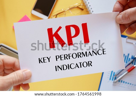 Office desktop - flat lay photo from above. Caption - KPI Key performance indicator. Idea, evaluation.