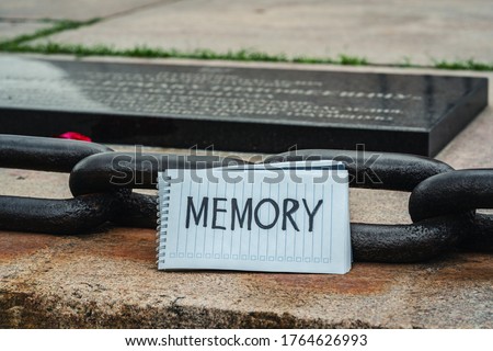 Inscription memory next to a metal chain