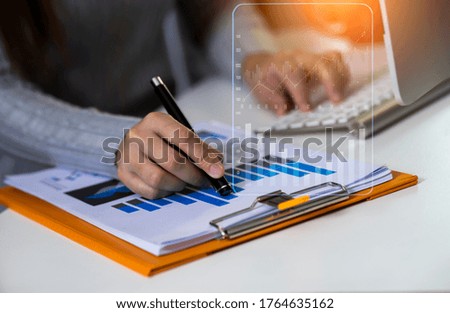 Businesswoman hand working at the office table with marketing network online, business finance technology concept, Background toned image blurred.