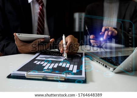Double exposure of businessman working on digital tablet and laptop with digital marketing virtual chart, Abstract icon, Business strategy concept, Background toned image blurred.