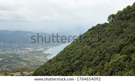 Landscape of the Gulf of Policastro in the south of Italy, hidden behind of the side of the hill full of forest trees