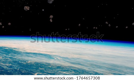 Stream of asteroids flying to Earth, space danger. View from orbit. Elements of this image furnished by NASA.