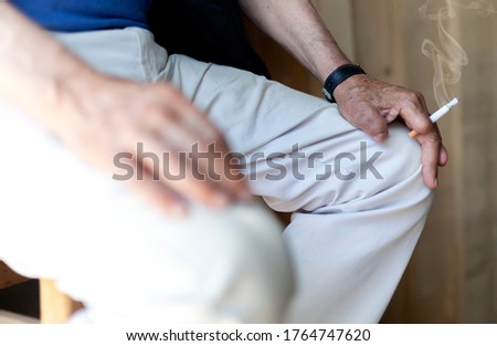 Old man and cigarette stock photo