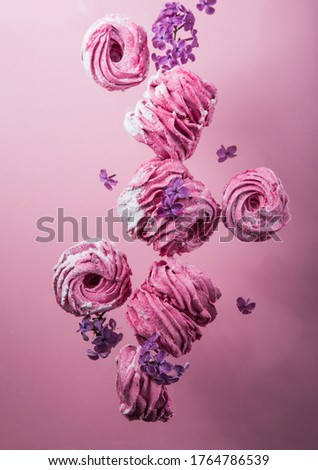 Russian Pink zephyr on pink  background. Set of homemade marshmallow Meringue, pansy. sweetness cusine