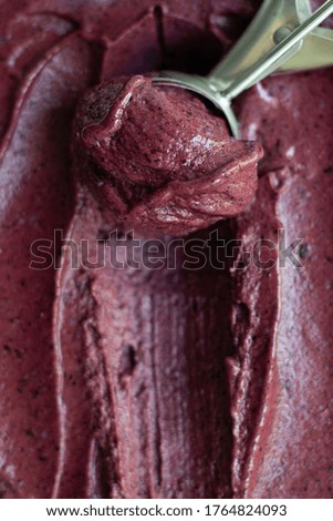 Homemade purple berry ice cream or sorbet with scoop. Close up texture. selective focus