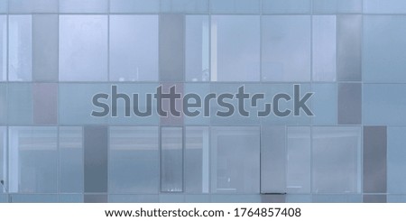 glass wall of building exterior of modern business center with blue windows