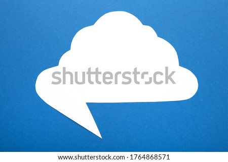 White paper speech bubble on blue background. Top view