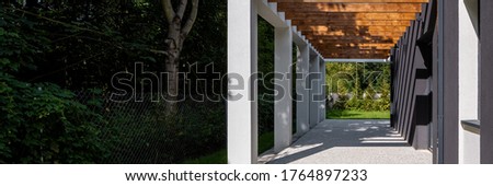 Panorama of stylish house veranda with cobblestone and wooden ceiling