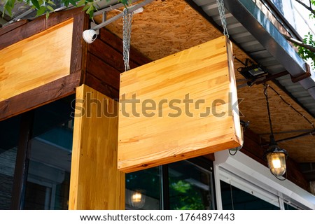 Mockup wooden signboard with coffee shop facade