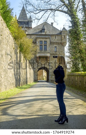 Braunfels castle gates and a woman in front of them. Hessen. Germany
