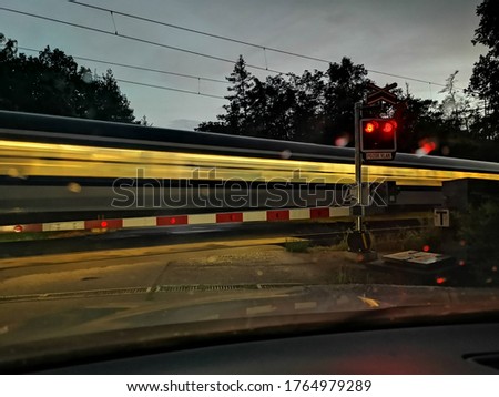 A fast train passes through a railway crossing