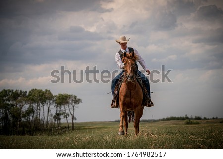 Cowboy Riding Across the Prairies on his Horse