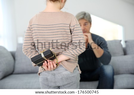Girl giving present to daddy on father's day