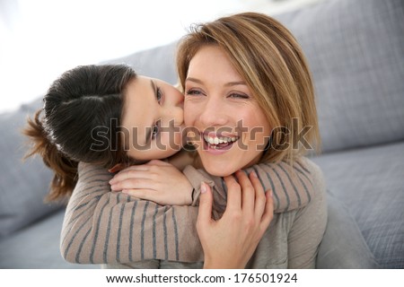 Little girl kissing her mom on cheek