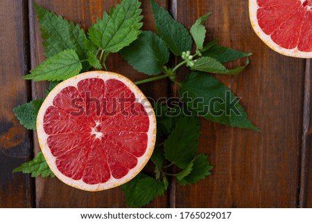 split grapefruit on a brown wooden background, top view, text space, citrus