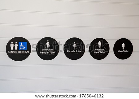 Signs and icons including braille for toilet facilities at a luxury hotel
