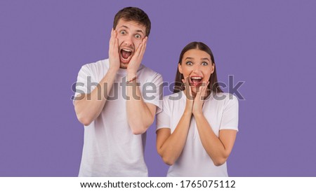 No Way. Closeup portrait of surprised spouses touching their cheeks, screaming isolated on pastel purple studio wall