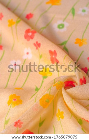 Texture background, silk fabric, small flowers on a beige background, Thin stitch. Red, beige tone print. Flower design