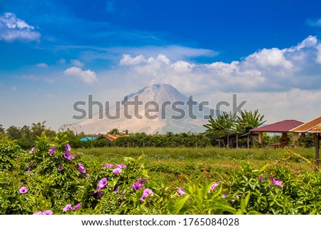 Mount Sinabung volcano on a sunny day in Northern Sumatra, Indonesia. Royalty-Free Stock Photo #1765084028