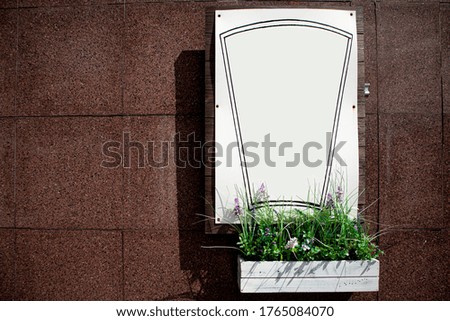 
White frame for advertising on a marble wall background.