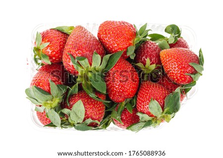 Ripe strawberries in transparent packaging isolated on white. Studio Photo