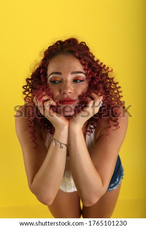 portrait of curly girl on a yellow background