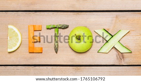 Word Detox made of  vegetables on wooden background. Royalty-Free Stock Photo #1765106792