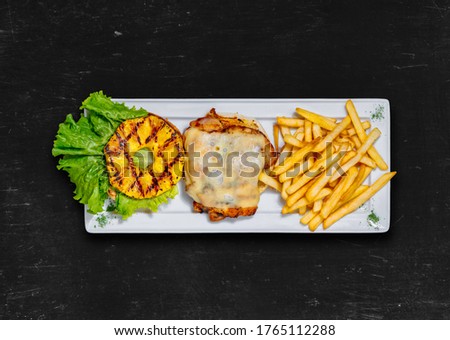 Healthy food. Hawaiian chicken burger. Grilled chicken, lettuce, fried pineapple ring, mozzarella cheese. Top view Royalty-Free Stock Photo #1765112288