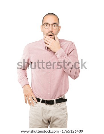 Astonished young man with a gesture of shock