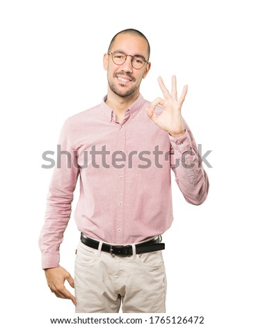 Happy young man doing an all right gesture