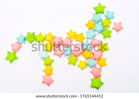 Stylized cat lined with colorful paper stars. Decor element in layout or scrapbooking.