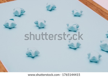 Solid blue background with paper stars in a children's style. Template for scrapbooking.
