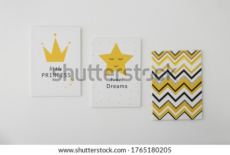 Different cute pictures on white wall. Children's room interior elements