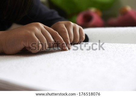blind children read text in braille language