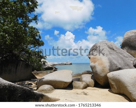 beach full of rocks and blue sky for the background 