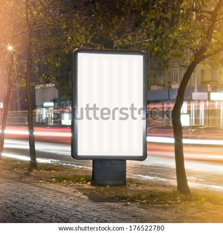 Vertical billboard shot long exposure on a busy evening street. Blank template