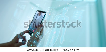 Telemedicine concept,Hand holding smartphone Medical Doctor online communicating the patient on VR medical interface with Internet consultation technology. Royalty-Free Stock Photo #1765238129