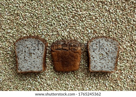 Three slices of bread made from organic green buckwheat with the addition of flaxseeds on the background of cereals.