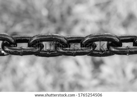 Close up of black and white chains with blurry grunge background. 