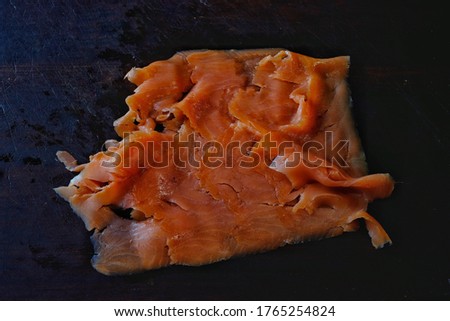 Smoked salmon isolated on black background