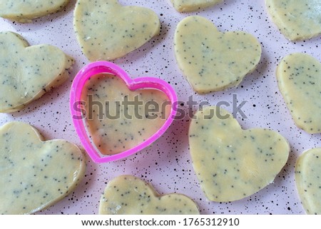 happy heart-shaped shortbread cookies with pink cookie cutter