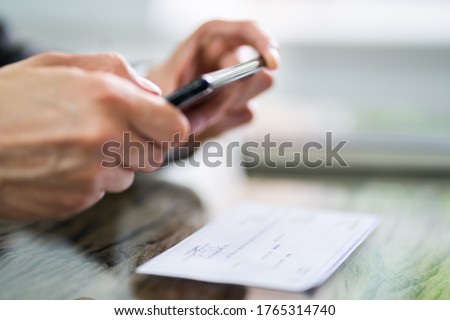 Scanning Remote Deposit Check Document Using Phone. Taking Photo Royalty-Free Stock Photo #1765314740