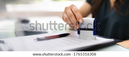 Record Or Permit Document Paper Stamper In Office Royalty-Free Stock Photo #1765316306