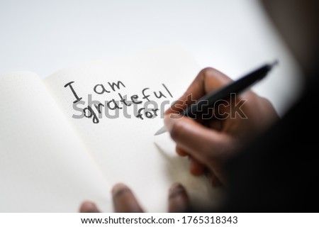 African American Women Writing In Gratitude Journal Royalty-Free Stock Photo #1765318343
